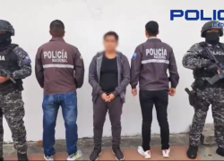 Fotografía del detenido, bajo custodia de policías.