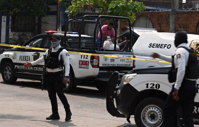 $!La policía hace guardia mientras personal forense retira los cuerpos del candidato del PRI a la alcaldía de Coyuca de Benítez, Aníbal Zúñiga Cortés, y su esposa, Ruby Bravo, asesinados en Acapulco, estado de Guerrero, México, el 16 de mayo de 2024.